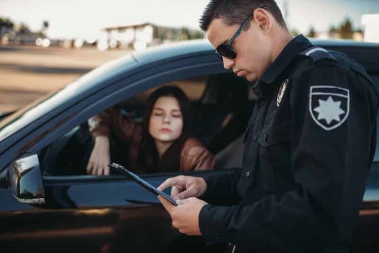 cop-in-uniform-checks-license-of-female-driver-2021-08-26-16-26-43-utc (1)