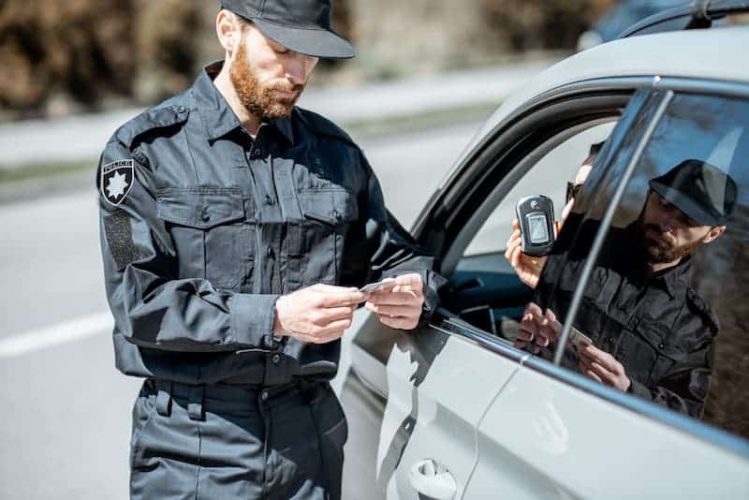 policeman-checking-woman-driver-for-alcohol-intoxi-2022-01-28-12-05-24-utc (2) (1)